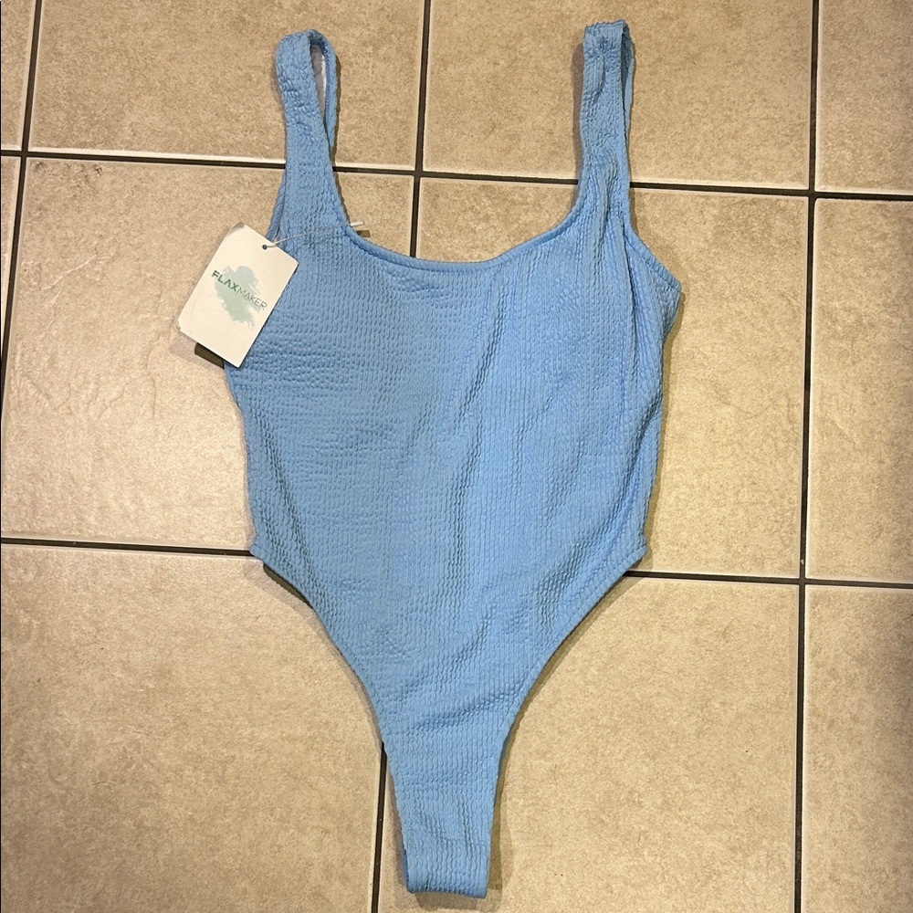 NWT FlaxMaker sky blue color, one piece swimsuit. ‘Waffle’ texture, high cut.